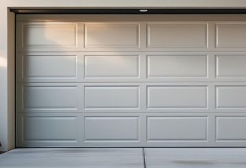 White paneled garage door installed in Chandler home driveway with clean, modern finish
