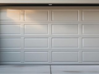 White paneled garage door installed in Chandler home driveway with clean, modern finish